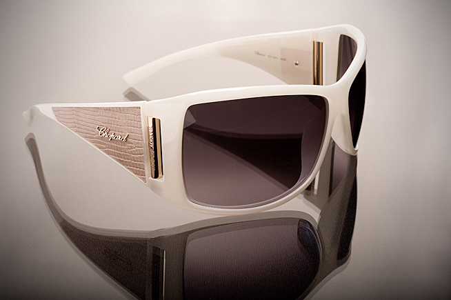 Luxury Chopard sunglasses photographed with soft studio lighting and reflective surface for high-end fashion accessory photography.