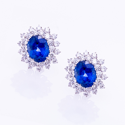 Luxury Harry Winston sapphire and diamond earrings photographed with precision studio lighting for high-end jewelry photography.