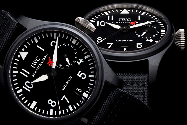 Luxury IWC pilot watches photographed with precision studio lighting against black background for high-end commercial watch photography.