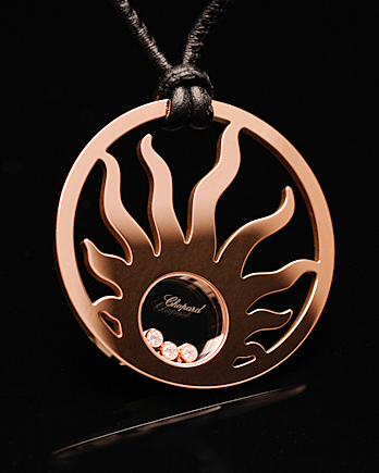 Luxury Chopard pendant photographed with controlled studio lighting against black background for high-end jewelry photography.
