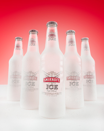 Smirnoff Ice bottles photographed with frozen effect and precision studio lighting for high-end commercial beverage photography.