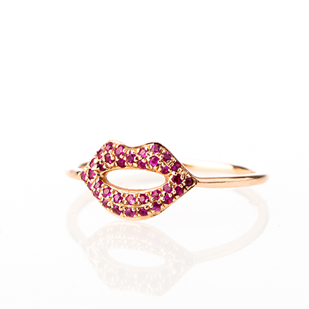 Luxury ruby lips ring photographed with soft high-key studio lighting for high-end jewelry photography.